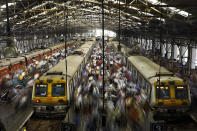 Commuters get off trains at the Church Gate railway station in Mumbai, India.