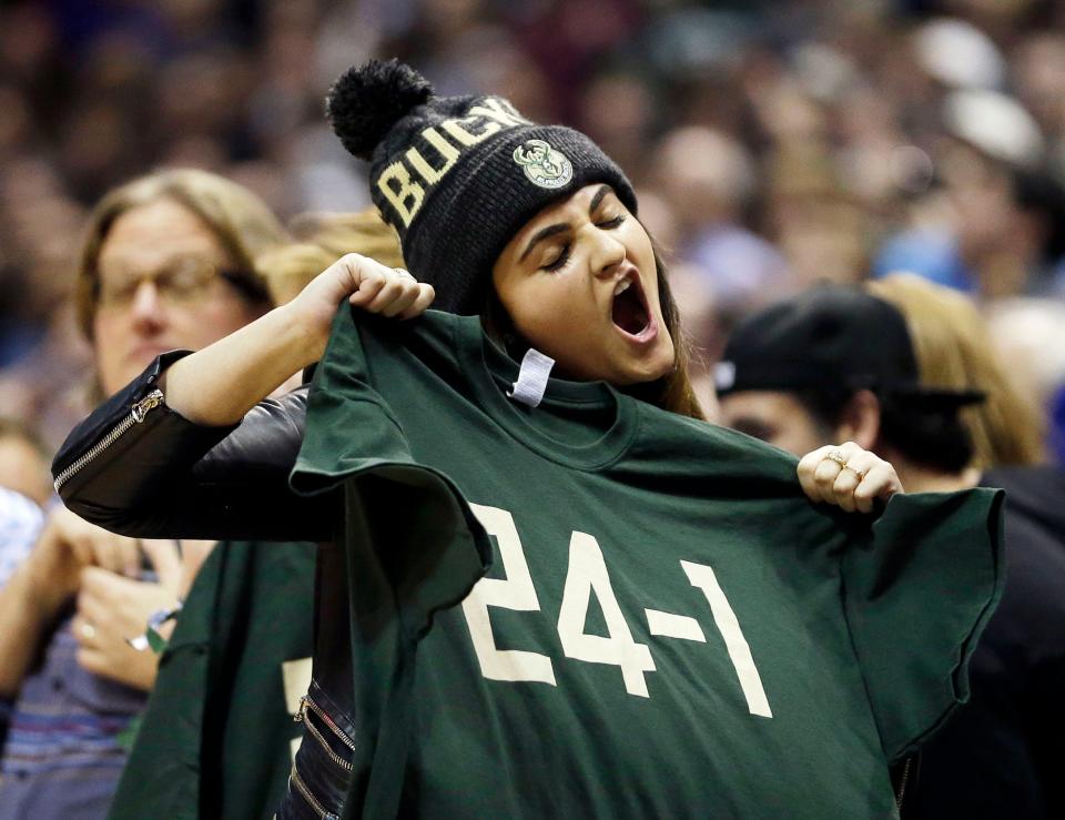 Mallory Edens holds up a "24-1" shirt during the second half of the Milwaukee Bucks' game against the Golden State Warriors on Dec. 12, 2015, the night the Bucks handed the Warriors their first loss of the season.