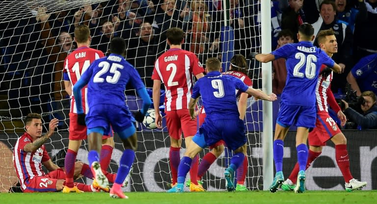 Leicester City's striker Jamie Vardy (C) scores during the UEFA Champions League quarter-final second leg football match between Leicester City and Club Atletico de Madrid at the King Power stadium in Leicester on April 18, 2017