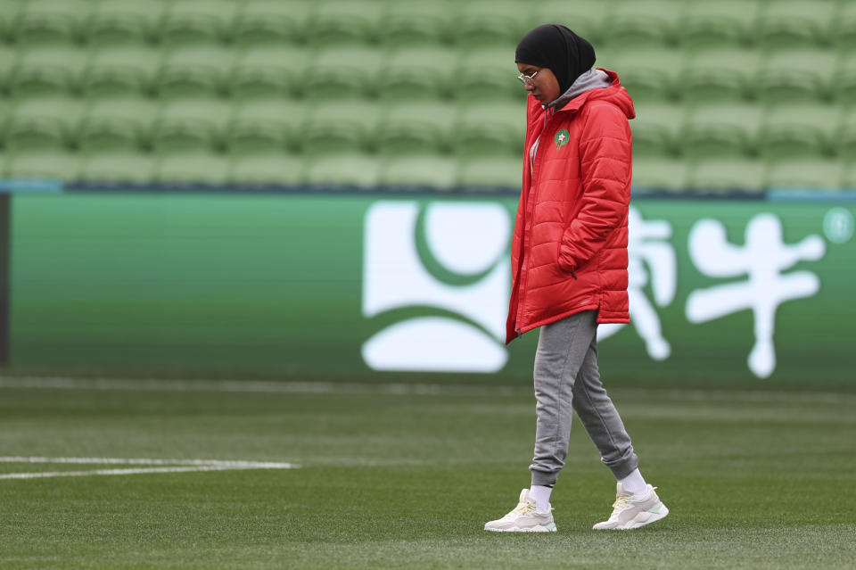 Morocco's Nouhaila Benzina walks around the ground during a familiarization tour ahead of her Women's World Cup Group H match with Germany in Melbourne, Australia, on Sunday, July 23, 2023. When Benzina steps onto the pitch Monday evening, she will be first player to compete in a senior-level FIFA Women's World Cup wearing a hijab. (AP Photo/Victoria Adkins)