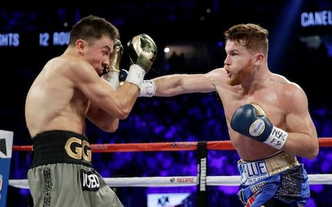 Canelo Alvarez, right, throws a right at Gennady Golovkin - Credit: AP