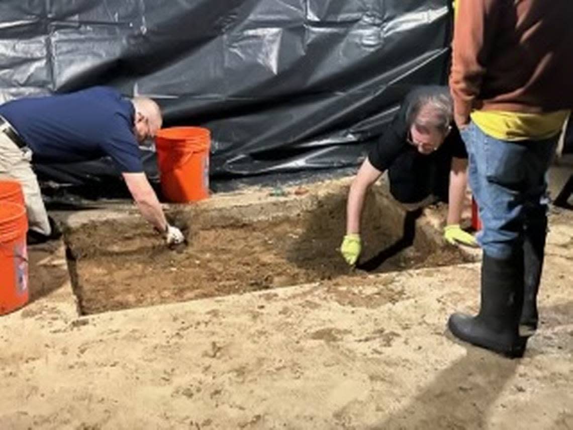 Investigators dig under part of a concrete patio on the property where the family of a missing child lived in Everman, Texas.
