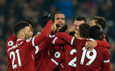 Liverpool huddle round Salah who scored their fourth - Credit: AFP