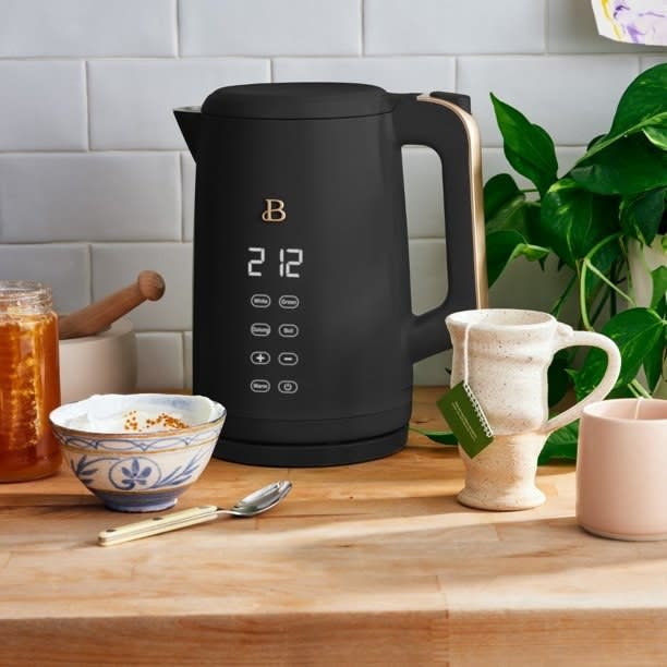 black electric kettle on a wood counter