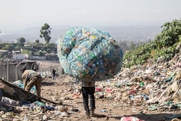 A man in Kenya carries a load of plastic garbage.  (Photo: SOPA Images via Getty Images)