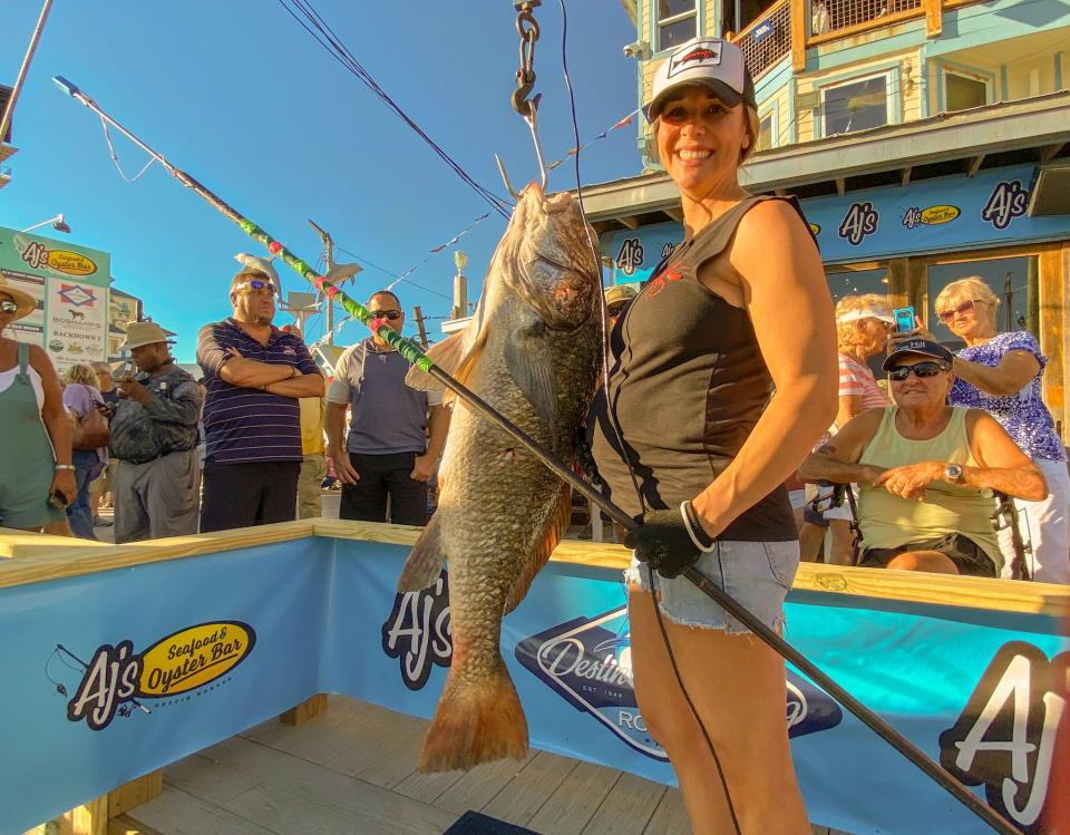 Julie Augustine shows off her 37.6-pound black drum she nailed with the 9-foot Bermudian slip tip polespear. The fish is a pending world record.