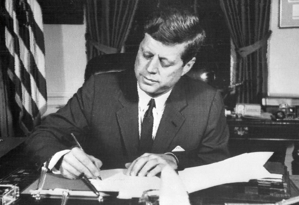 U.S. President John Fitzgerald Kennedy signs the order of naval blockade of Cuba, on October 24, 1962 in the White House, during the Cuban Missile Crisis. (AFP/Getty Images) 