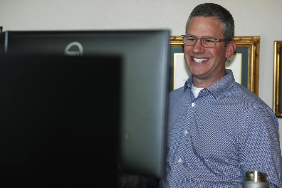 In this Monday, July 1, 2019, photo, software engineer Joe Wilson works in his home in Highlands Ranch, Colo. The tariffs that the Trump administration has placed on thousands of products imported from China and retaliatory duties placed on U.S. goods are affecting many small businesses, even if they’re not importers or exporters. Wilson might have to put off hiring freelancers if he feels the ripple effects of tariffs that his customers must pay. (AP Photo/David Zalubowski)