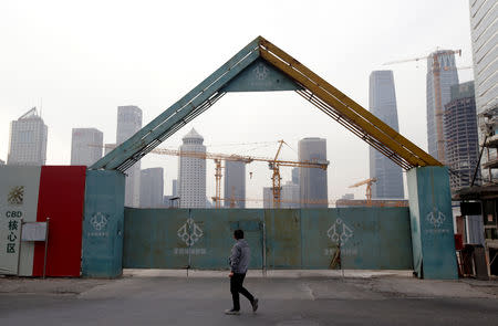 A man walks outside the construction sites in Beijing's central business area, China January 18, 2019. REUTERS/Jason Lee