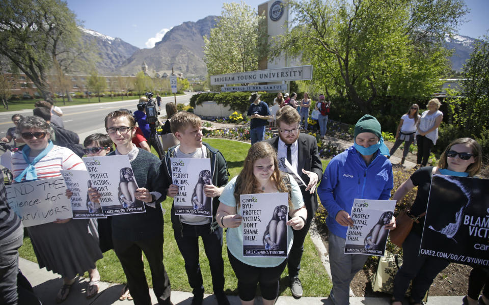 FILE - Protesters stand in solidarity with rape victims on the campus of Brigham Young University during a sexual assault awareness demonstration, in Provo, Utah, April 20, 2016. The Biden administration proposed a dramatic overhaul of campus sexual assault rules on Thursday, June 23, 2022, acting to expand protections for LGBTQ students, bolster the rights of victims and widen colleges' responsibilities in addressing sexual misconduct. (AP Photo/Rick Bowmer, File)