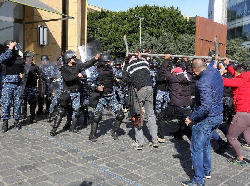 Protestors scuffle with the riot police during a protest against the political elite in Beirut