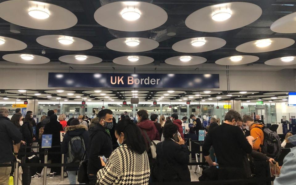 People queue at terminal 5 of Heathrow Airport, as the coronavirus pandemic continues and Britain tightens travel restrictions - PIA JOSEPHSON via REUTERS