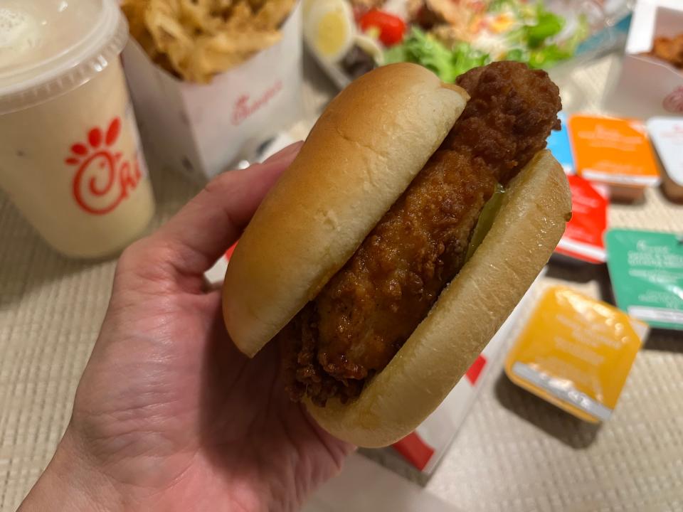 hand holding an original chick fil a chicken sandwich from chick fil a in toronto