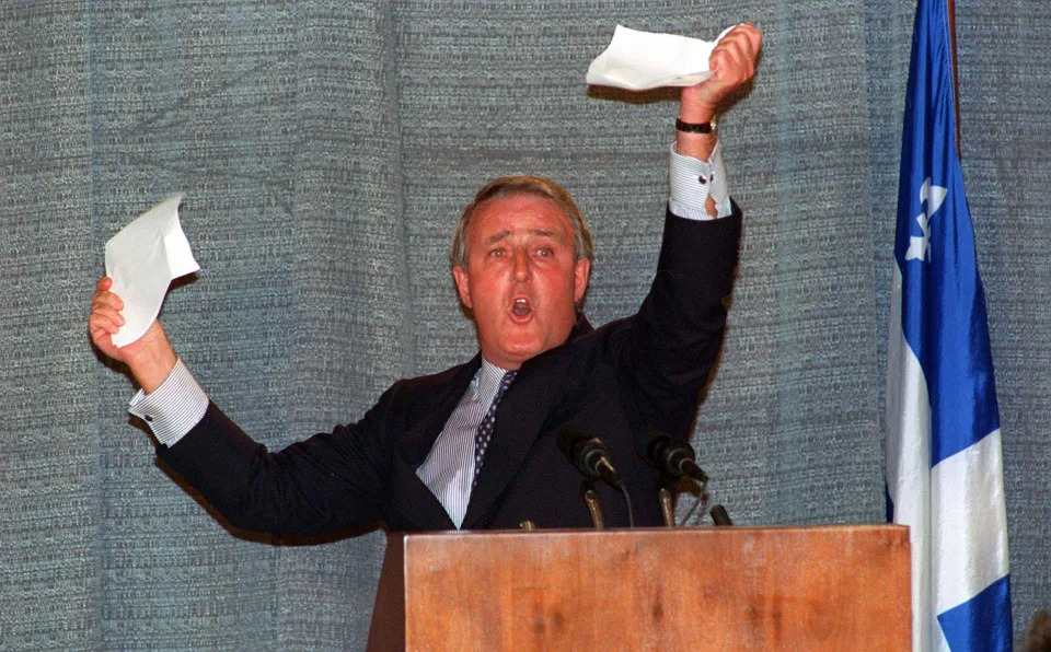 <p>Prime Minister Brian Mulroney holds up a piece of paper he had torn during a speech in Sherbrooke, Quebec, Monday. Mulroney was demonstrating that a No vote on the referendum would rip apart the 31 points Quebec got in the Charlottetown agreement. </p>