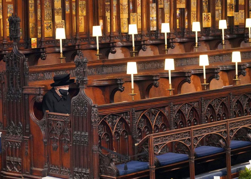 Britain's Queen Elizabeth II sits alone in St. George’s Chapel during the funeral of Prince Philip, the man who had been by her side for 73 years, at Windsor Castle, Windsor, England, Saturday April 17, 2021. Prince Philip died April 9 at the age of 99 after 73 years of marriage to Britain's Queen Elizabeth II. (Jonathan Brady/Pool via AP)