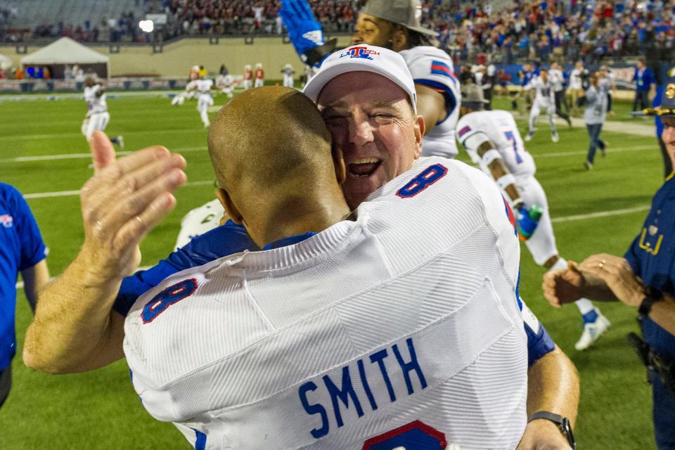 Dec 26, 2019; Shreveport, Louisiana, USA; Louisiana Tech Bulldogs head coach Skip Holtz and quarterback J'Mar Smith (8) celebrate during the second half against the Miami Hurricanes at Independence Stadium. Mandatory Credit: Justin Ford-USA TODAY Sports