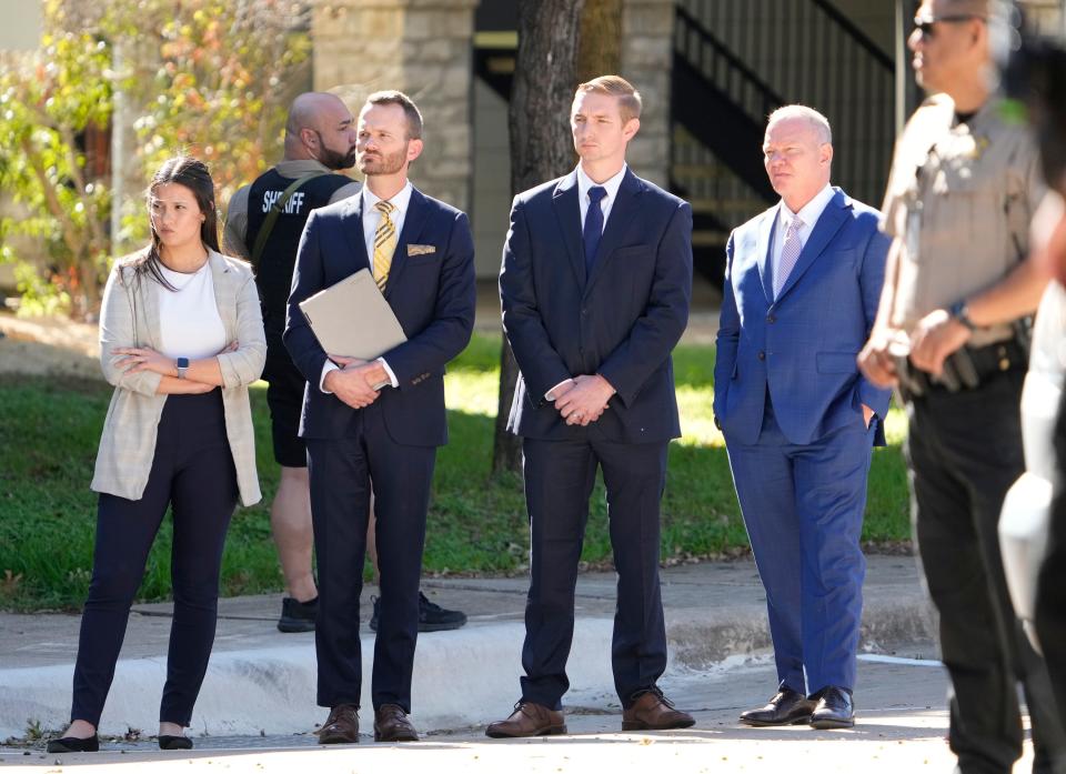 Austin police officer Christopher Taylor, second from right, with his attorneys, left to right, Lindsey Adams, Ken Ervin and Doug O’Connell watch Nov. 7 as jurors visit the parking lot where Taylor fatally shot Michael Ramos in 2020.