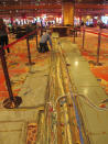 A worker inspects electrical cables on the casino floor of Bally's casino in Atlantic City N.J., Monday, June 14, 2021. The new owners of Bally's Atlantic City are attempting to revive a comatose casino in perhaps the most cutthroat gambling market in America. Rhode Island-based Bally's Corporation is spending at least $90 million on the Boardwalk casino over the next five years, including hotel room makeovers, a renovation of the casino floor, new slot machines and restaurants, and more live entertainment. (AP Photo/Wayne Parry)