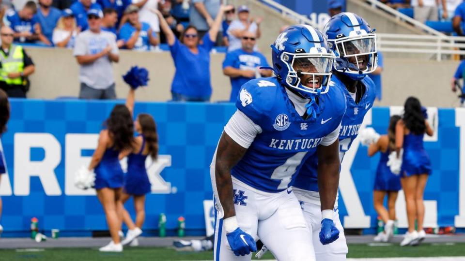 Kentucky defensive back Jalen Geiger (4) celebrates with JQ Hardaway (6) after Geiger recovered a second quarter fumble and returned it 69 yards for a touchdown against Ball State on Saturday.