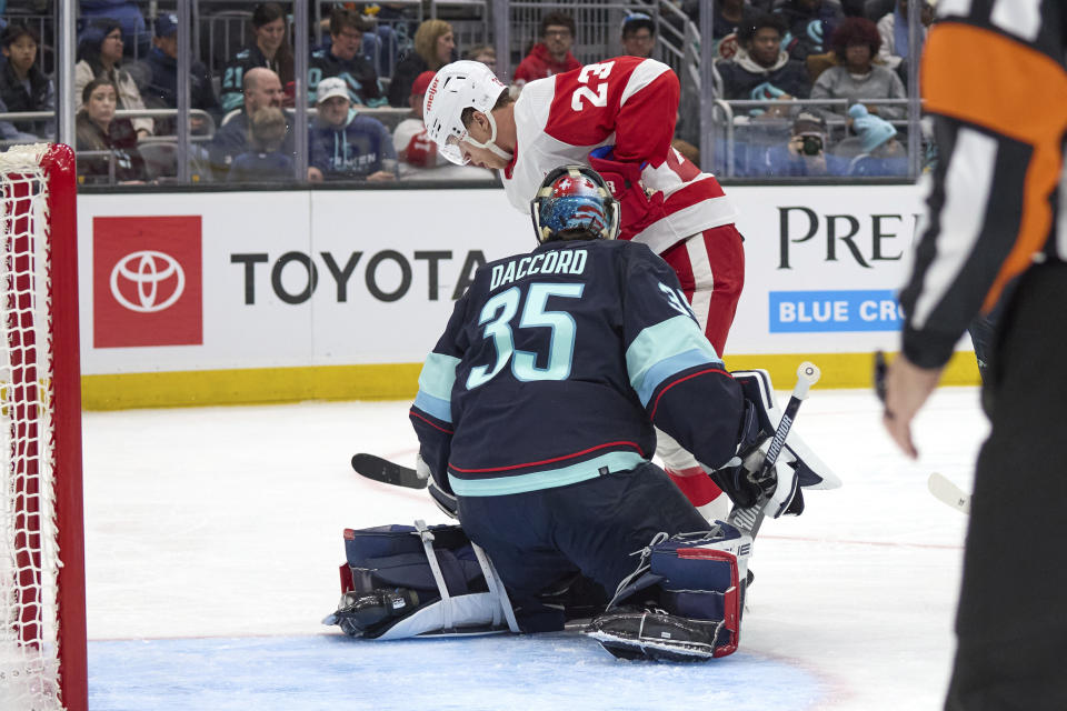 Detroit Red Wings left wing Lucas Raymond shovels the puck past Seattle Kraken goaltender Joey Daccord for a goal during the second period of an NHL hockey game, Monday, Feb. 19, 2024, in Seattle. (AP Photo/John Froschauer)