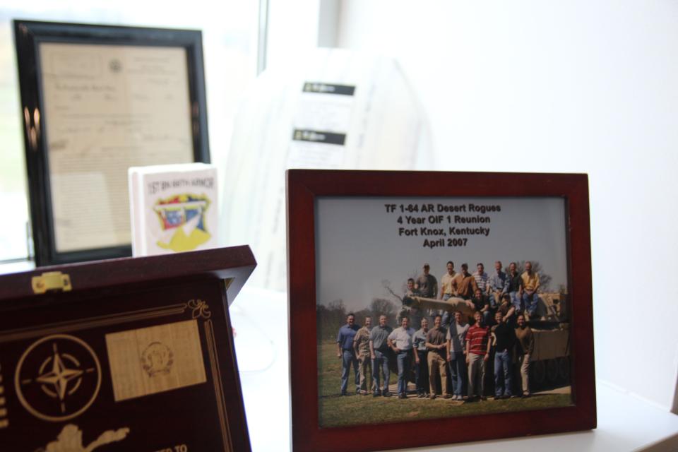 In his Fort Benning, Georgia office, Brig. Gen. Larry Burris, today the Infantry School commandant, displays a Task Force 1-64 reunion photo. The unit led the Army’s drive into Baghdad in April 2003, including the famous Thunder Runs. (Staff/Davis Winkie)