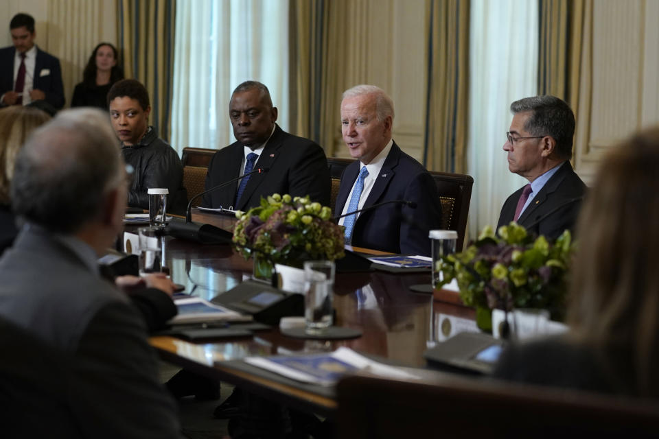 President Joe Biden, second from right, flanked by Defense Secretary Lloyd Austin, on the left, and Health and Human Services Secretary Xavier Becerra, on the right, speaks during a meeting of the White House Competition Council in the State Dining Room of the White House in Washington, Monday, Sept. 26, 2022. (AP Photo/Susan Walsh)