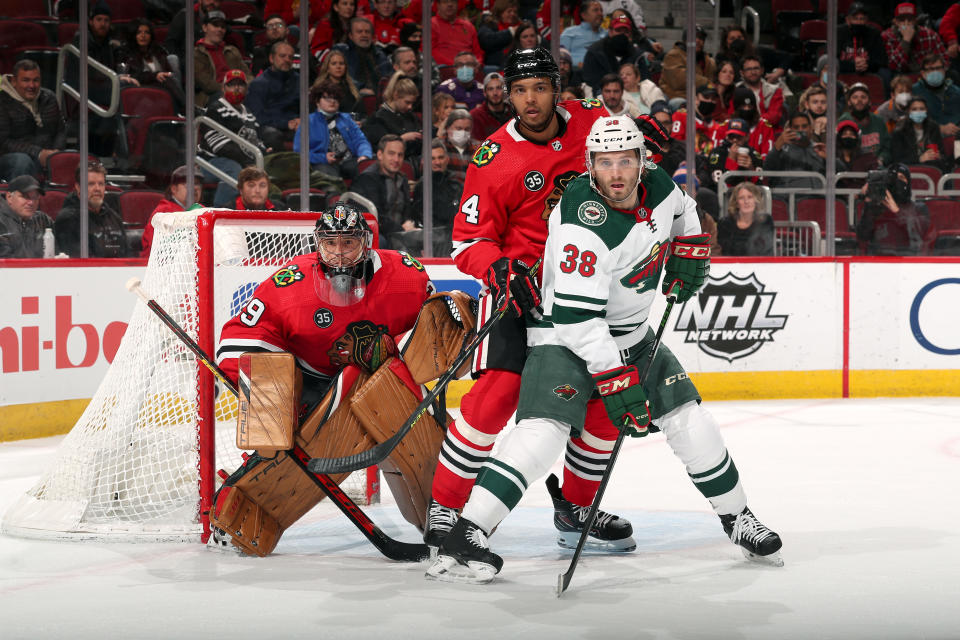 CHICAGO, ILLINOIS - FEBRUARY 02: Ryan Hartman #38 of the Minnesota Wild and Seth Jones #4 of the Chicago Blackhawks wait in position in front of goalie Marc-Andre Fleury #29 in the second period at United Center on February 02, 2022 in Chicago, Illinois. (Photo by Chase Agnello-Dean/NHLI via Getty Images)