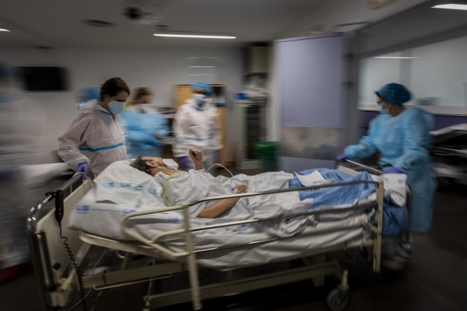 FILE - In this Feb. 17, 2021, file photo, a COVID-19 patient is transferred to the "red zone," an area reserved for treating those suffering from COVID-19, in the Severo Ochoa Hospital in Leganes on the outskirts of Madrid, Spain. Optimism is spreading in the U.S. as COVID-19 deaths plummet and states ease restrictions and open vaccinations to younger adults. But across Europe, dread is setting in with another wave of infections that is closing schools and cafes and bringing new lockdowns. (AP Photo/Bernat Armangue, File)