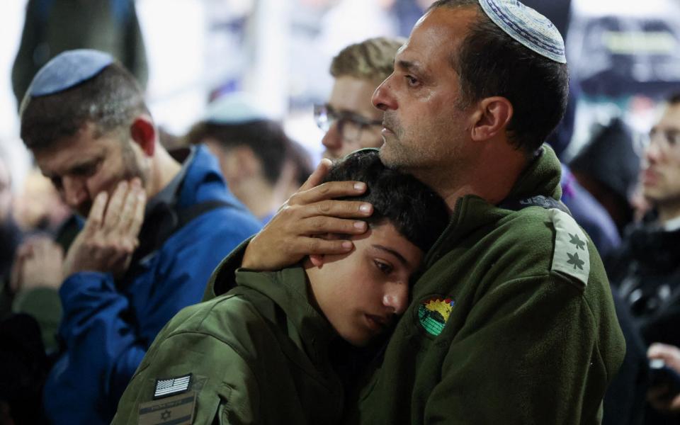 People mourn Israeli soldier Captain Daniel Perez, who was killed in the deadly October 7 attack by militants from Palestinian Islamist group Hamas, at his funeral at Mount Herzl military cemetery in Jerusalem, March 18, 2024. Israel's government confirmed that Perez's body is being held by Hamas in Gaza. REUTERS/Nir Elias