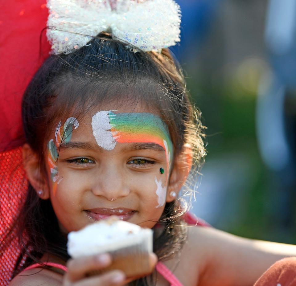 Enjoying a delicious cupcake, Ira Chaudhari, 5, of Sarasota. Thousands of people attended the 1st annual 'Good Friday in Payne Park' hosted by First Sarasota's Downtown Baptist Church.