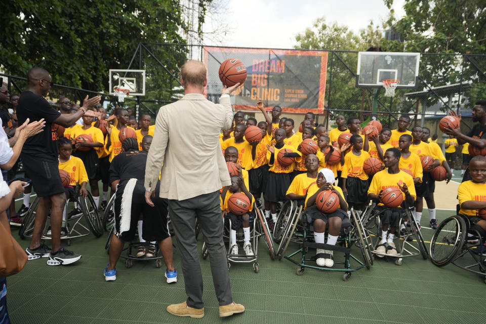 Prince Harry, speaks to children during the Giant of Africa Foundation at the Dream Big Basketball clinic in Lagos Nigeria, Sunday, May 12, 2024. Prince Harry and his wife Meghan are in Nigeria to champion the Invictus Games, which Prince Harry founded to aid the rehabilitation of wounded and sick servicemembers and veterans. (AP Photo/Sunday Alamba)