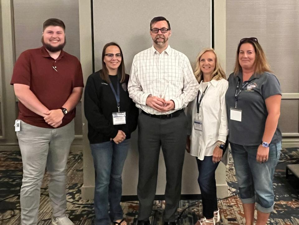 Marion Municipal Court Chief Probation Officer Tom Stotts, center, is the 2023 recipient of the Vince Polito Executive Leadership Award presented by the Ohio Chief Probation Officers Association. Stotts is pictured with Marion Municipal Court probation officers, from left, Kendrick Beard, Lindsey Cochran, Nancy McDuffie, and Meghan Stose.