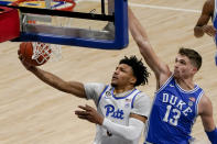 Pittsburgh's Ithiel Horton, left, shoots after getting by Duke's Joey Baker (13) during the first half of an NCAA college basketball game, Tuesday, Jan. 19, 2021, in Pittsburgh. (AP Photo/Keith Srakocic)