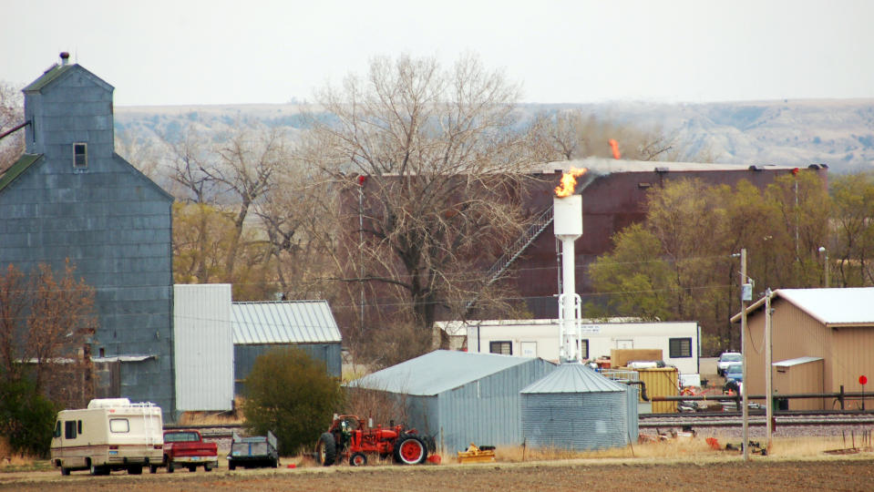 In this April 19, 2012, photo excess gas is flared from a rail loading facility in Dore, N.D. The western North Dakota town has seen an economic and population turnaround with increased oil activity in the region. (AP Photo/James MacPherson)