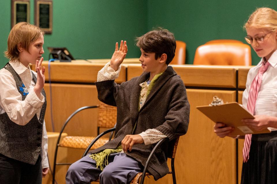 (From left) Bianca Shea, 11, plays the Bailiff, Jake Bonazzi, 11, plays Rumplestiltskin and Danielle Vierno, 13, plays the Plaintiff in Rumpelstiltskin vs. the Queen. Fairy Tale Trials explore moral dilemmas using children's stories. Shown in the Hawthorne municipal building on Saturday, May, 6, 2023.