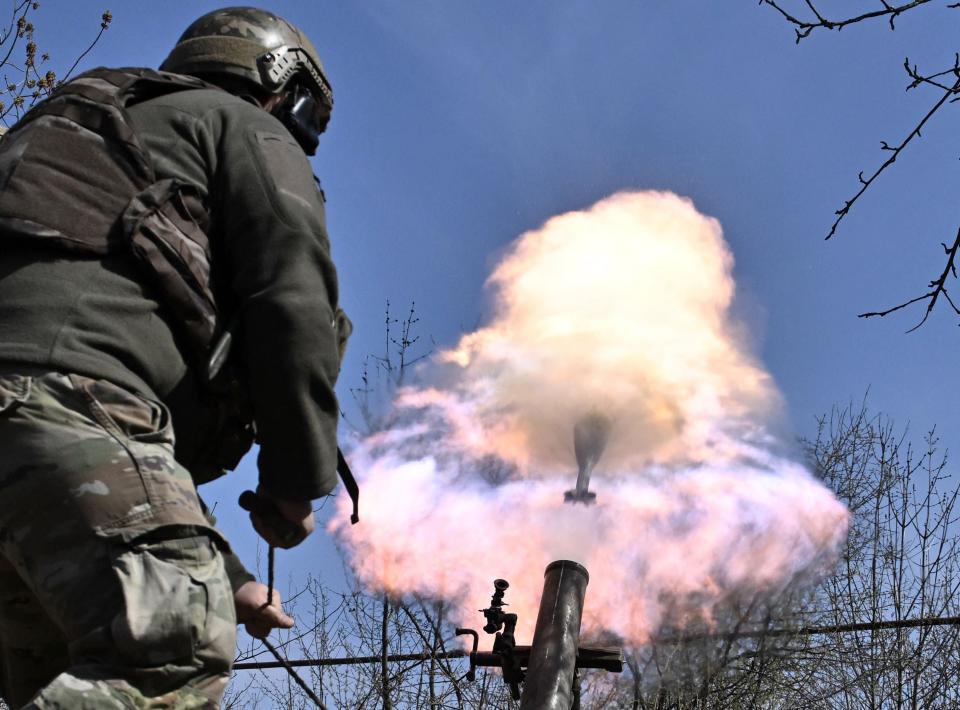 Belarusian volunteer soldiers from the Kastus Kalinouski regiment fire a mortar near Bakhmut (AFP/Getty)