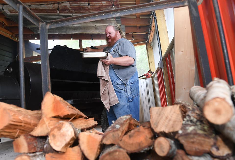 Jolly Rogers BBQ is now open in Pacolet. The business is owned by the husband and wife team of Josh and Jennifer Rogers. Here, Josh Rogers prepares meat for guests.