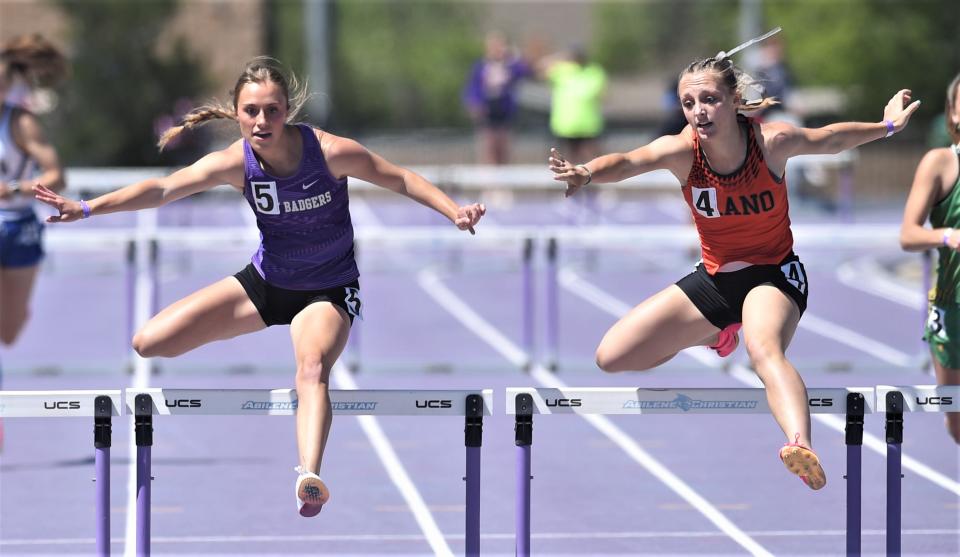 Merkel's Avery Holloway, left, and Llano's Gwyn Burnett leap over the final hurdle in the 300-meter hurdles at the Region I-3A meet Saturday, April 29, 2023, at ACU's Elmer Gray Stadium. Holloway nipped Burnett at the wire to win the race. Hollaway ran a 44.68, while Burnett ran 44.73.