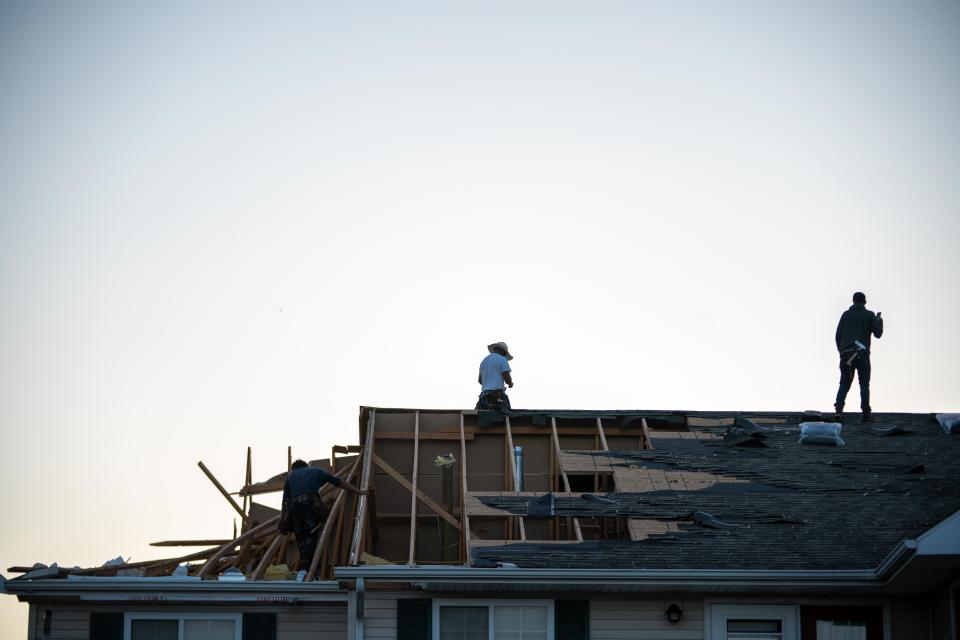 Belfor Restoration works on the roof of Gloria Thompson at Clary Crossing Apartments Sunday, June 25, 2023, after a tornado hit in Greenwood.