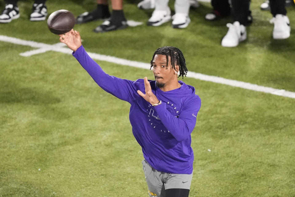 LSU quarterback Jayden Daniels (5) goes through passing drills during LSU's NCAA football pro day in Baton Rouge, La., Wednesday, March 27, 2024. (AP Photo/Gerald Herbert)