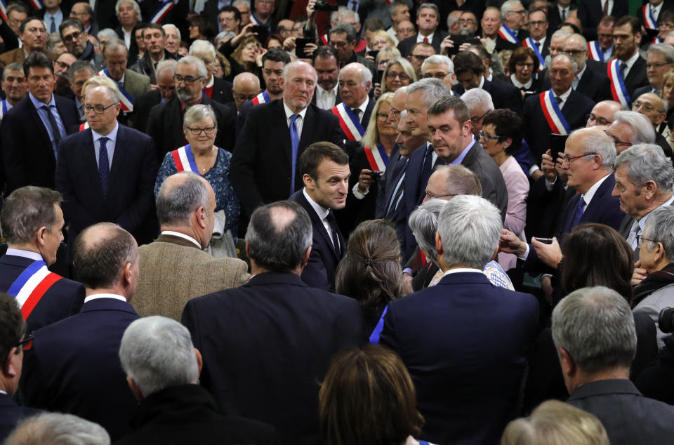 French President Emmanuel Macron arrives for the "grand debate" with mayors from rural Normandy in Grand Bourgtheroulde, France, Tuesday, Jan.15, 2019. French President Emmanuel Macron encouraged people to express their list of grievances and propose changes to the country's economy during a "grand debate" aimed at appeasing the yellow vest movement, following weeks of anti-government protests. (Philippe Wojazer/Pool Photo via AP)