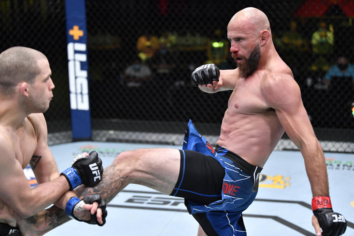 LAS VEGAS, NEVADA - MAY 08: In this handout image provided by UFC, (R-L) Donald 'Cowboy' Cerrone kicks Alex Morono in a welterweight fight during the UFC Fight Night event at UFC APEX on May 08, 2021 in Las Vegas, Nevada. (Photo by Chris Unger/Zuffa LLC via Getty Images)