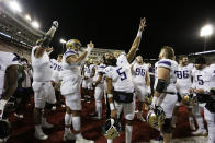 Washington players sing the school's fight song after the team's 51-33 win against Washington State in an NCAA college football game, Saturday, Nov. 26, 2022, in Pullman, Wash. (AP Photo/Young Kwak)