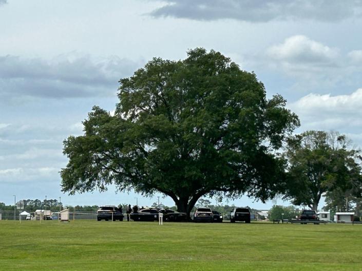 Florida Highway Patrol officers gather under an oak tree at Florida State Prison in Raiford Wednesday, April 12, 2023, hours before Louis Gaskin is scheduled to be put to death.