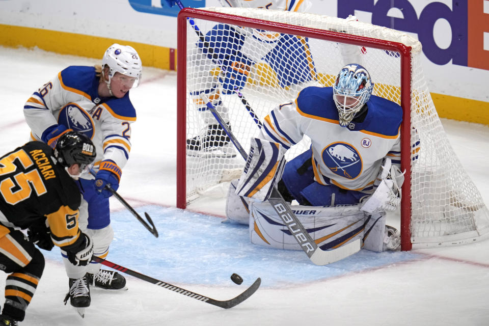 Pittsburgh Penguins' Noel Acciari (55) can't get a shot past Buffalo Sabres goaltender Ukko-Pekka Luukkonen (1) with Rasmus Dahlin (26) defending during the first period of an NHL hockey game in Pittsburgh, Saturday, Nov. 11, 2023. (AP Photo/Gene J. Puskar)