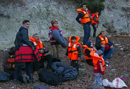 Migrants wearing life jackets wait for a dinghy to sail off for the Greek island of Lesbos from the Turkish coastal town of Dikili, Turkey, April 6, 2016. REUTERS/Murad Sezer