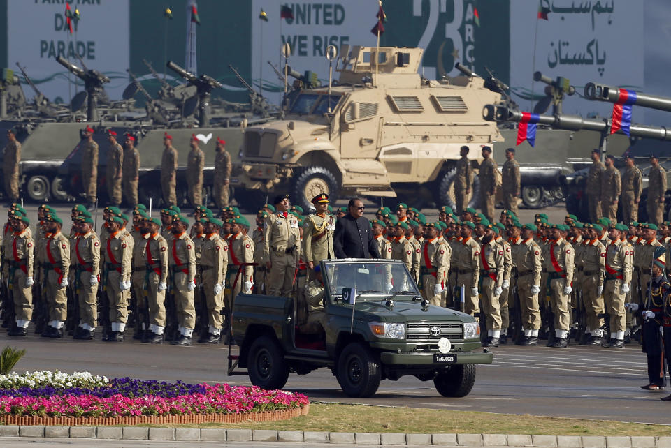 Pakistan's President Mamnoon Hussain, center on a military vehicle, reviews a military parade to mark Pakistan's Republic Day, in Islamabad, Pakistan, Thursday, March 23, 2017. Hussain says Pakistan is ready to hold talks with India on all issues, including Kashmir, as he opened the annual military parade. During the parade, attended by several thousand people, Pakistan displayed nuclear-capable weapons, tanks, jets, drones and other weapons systems. (AP Photo/Anjum Naveed)