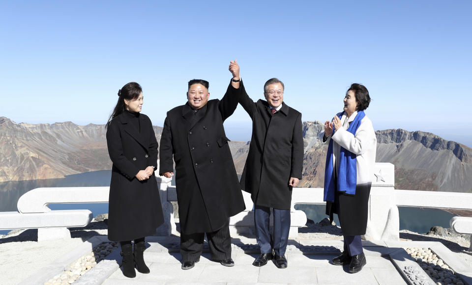 South Korean President Moon Jae-in, second from right, and his wife Kim Jung-sook, right, stand with North Korean leader Kim Jong Un, second from left, and his wife Ri Sol Ju on the Mount Paektu in North Korea, Thursday, Sept. 20, 2018. (Pyongyang Press Corps Pool via AP)