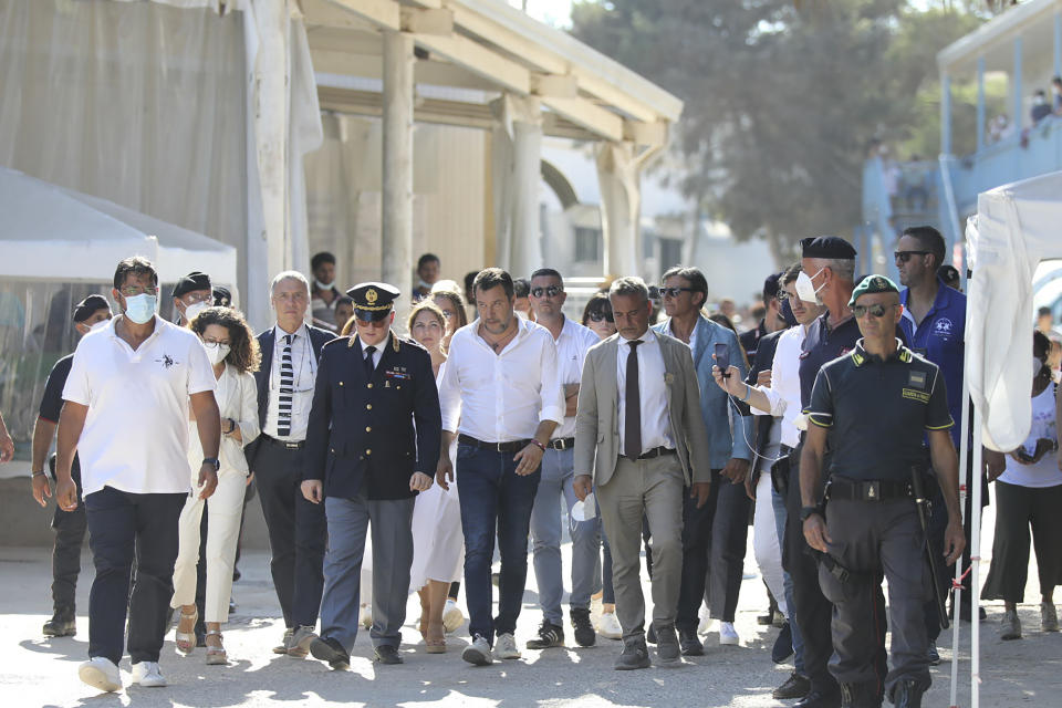 Italy's former Interior minister, Matteo Salvini and Leader of The League party, center, visits migrant reception center in the Sicilian Island of Lampedusa, Italy, Thursday, Aug. 4, 2022. Salvini is making a stop Thursday on Italy's southernmost island of Lampedusa, the gateway to tens of thousands of migrants arriving in Italy each year across the perilous central Mediterranean Sea. (AP Photo/David Lohmueller)