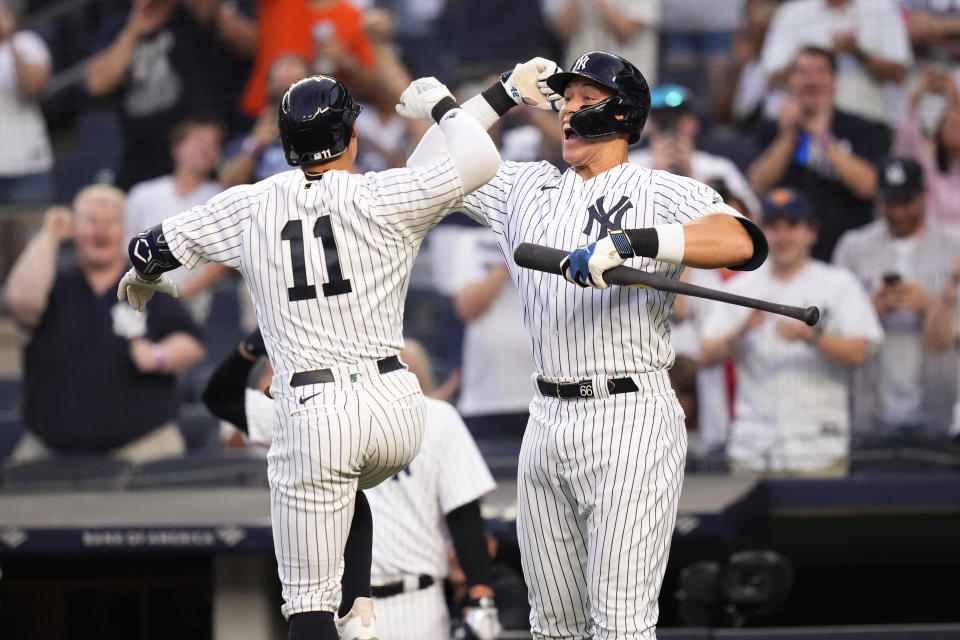 New York Yankees' Aaron Judge, right, celebrates with Anthony Volpe after Volpe hit a home run against the Minnesota Twins during the first inning of a baseball game Friday, April 14, 2023, in New York. (AP Photo/Frank Franklin II)